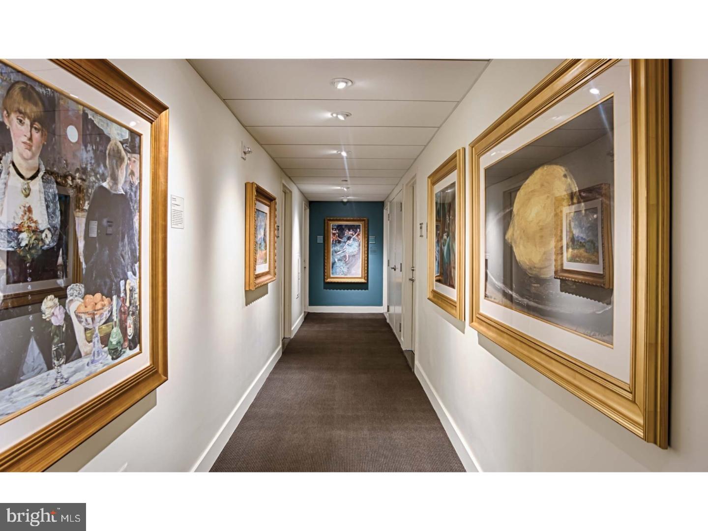 2200 Benjamin Franklin Parkway, Unit 1BE0706 Philadelphia, PA 19130 - Photo 7 of 18 a hallway with wooden floor and windows