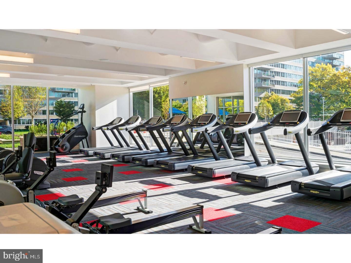2200 Benjamin Franklin Parkway, Unit 1BE0706 Philadelphia, PA 19130 - Photo 9 of 18 a room with gym equipment and large windows