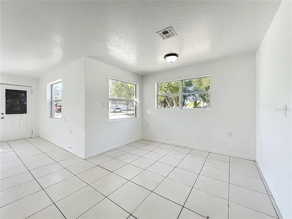 a room with a ceiling fan and a window
