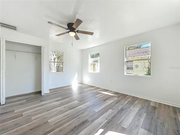 a view of a backyard with large tree