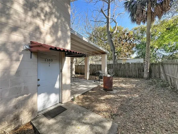 a view of a dining room with furniture and a chandelier