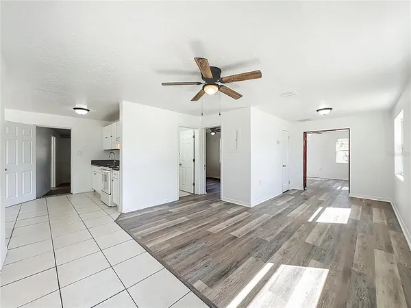 a kitchen with white cabinets and appliances