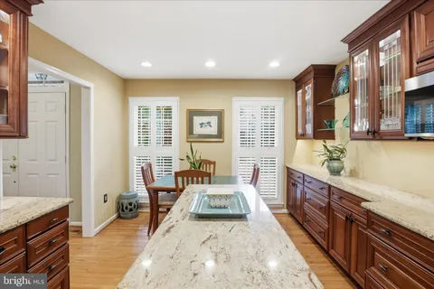 a kitchen with stainless steel appliances granite countertop a refrigerator stove and sink