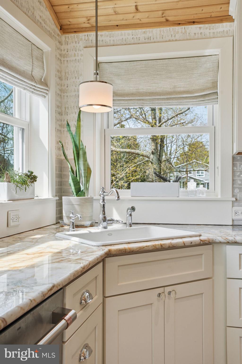 7806 Summit Drive Pasadena, MD 21122 - Photo 20 of 74 a bathroom with a granite countertop sink and a window