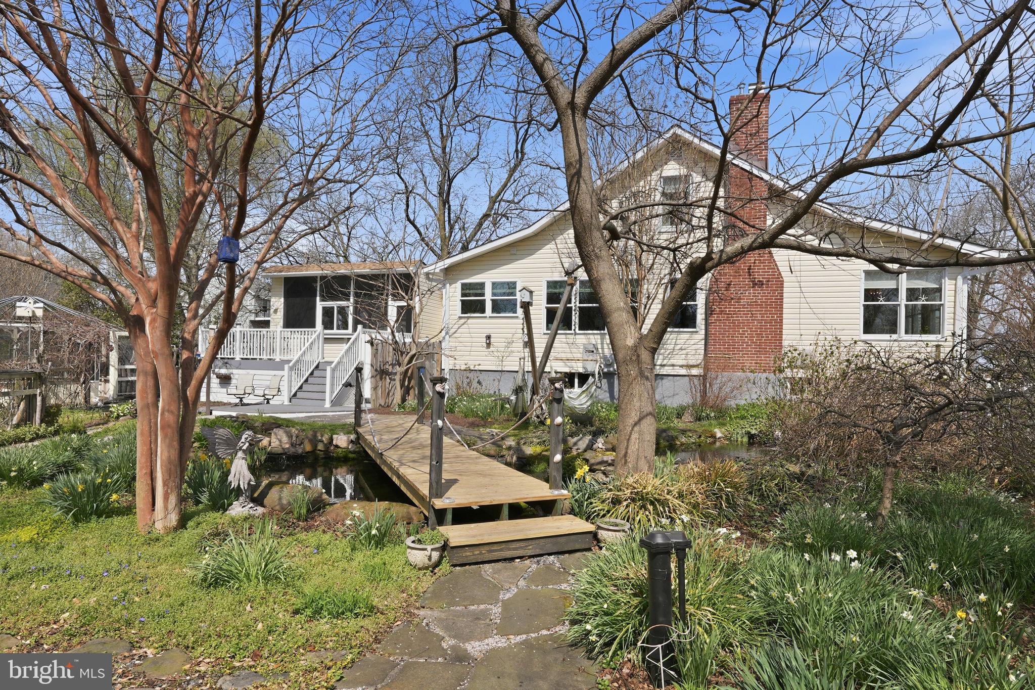 7806 Summit Drive Pasadena, MD 21122 - Photo 3 of 74 a front view of a house with garden