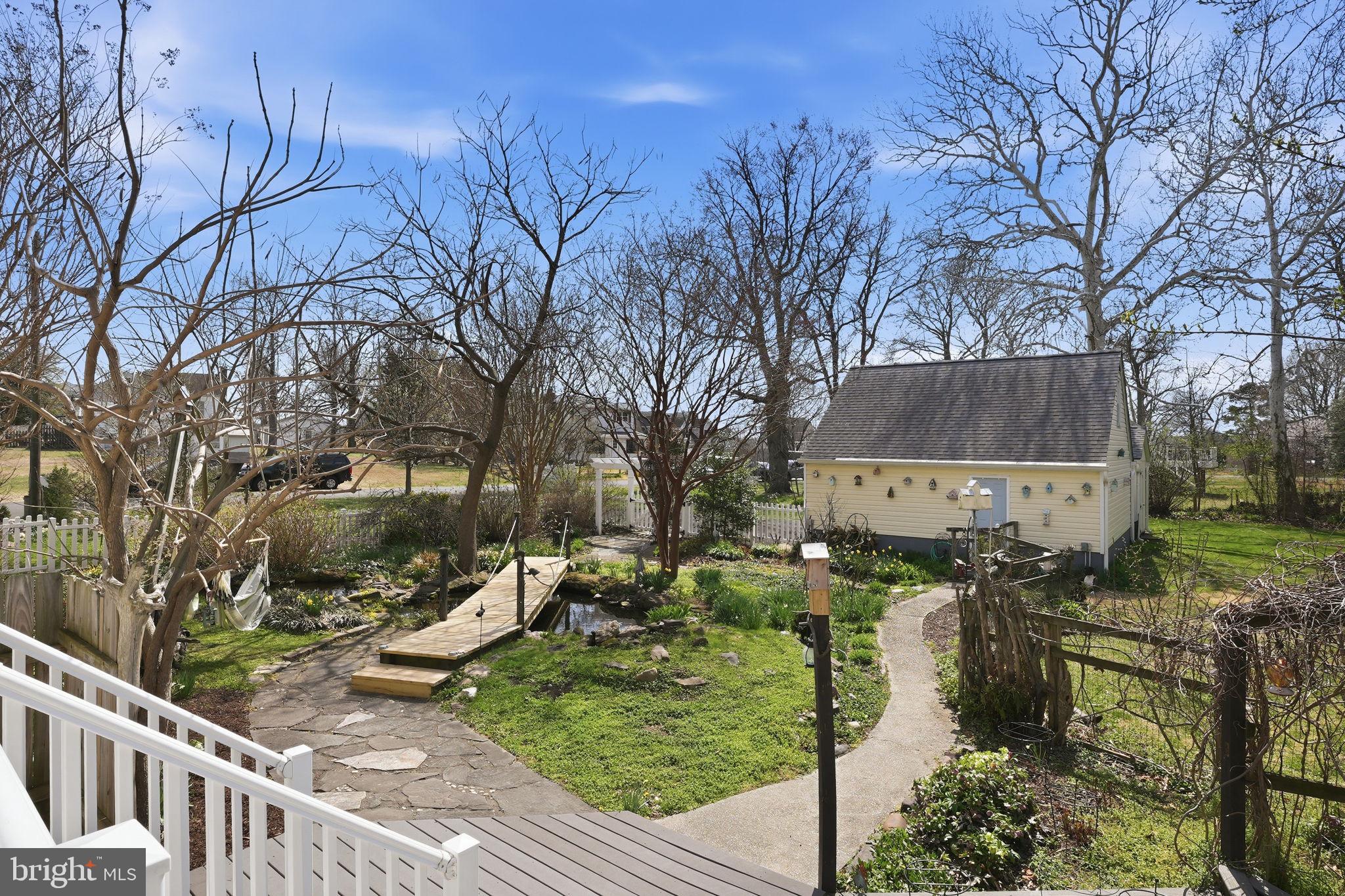7806 Summit Drive Pasadena, MD 21122 - Photo 40 of 74 a backyard of a house with table and chairs