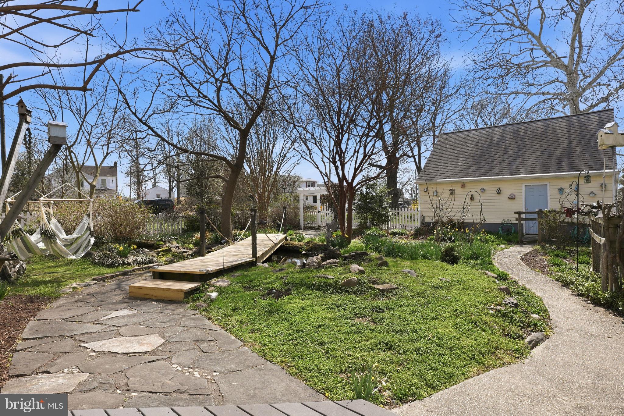 7806 Summit Drive Pasadena, MD 21122 - Photo 42 of 74 a view of a garden with a bench