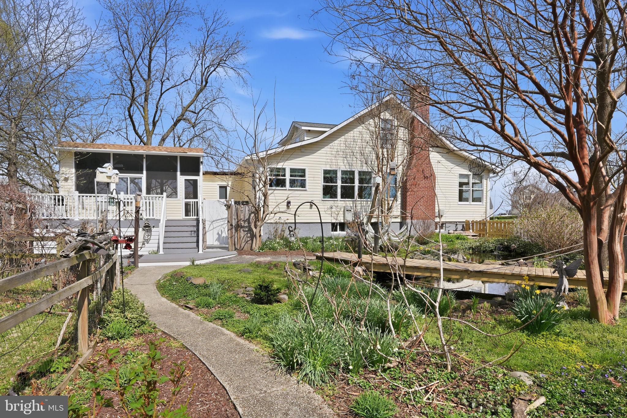 7806 Summit Drive Pasadena, MD 21122 - Photo 43 of 74 a front view of a house with porch yard and outdoor seating