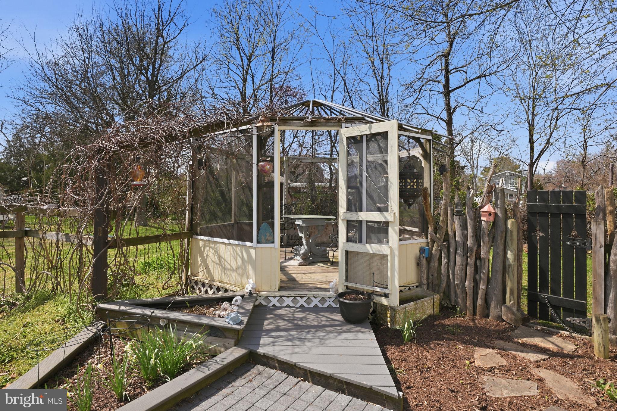 7806 Summit Drive Pasadena, MD 21122 - Photo 47 of 74 a front view of a house with garden