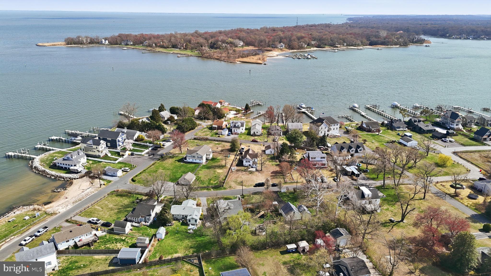 7806 Summit Drive Pasadena, MD 21122 - Photo 65 of 74 an aerial view of a houses with a lake view