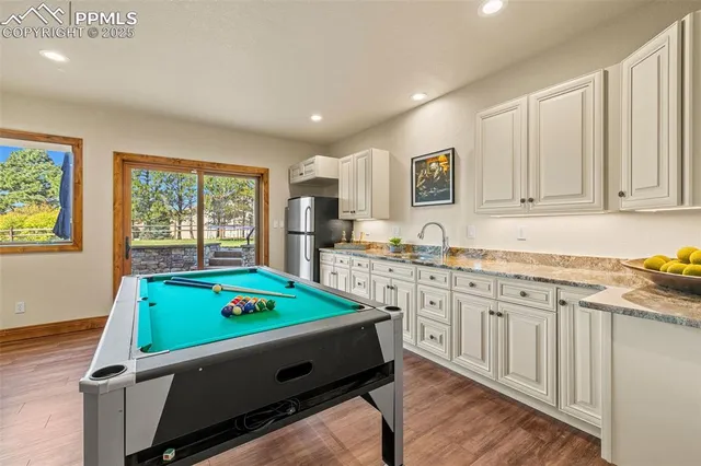 a room with pool table and windows