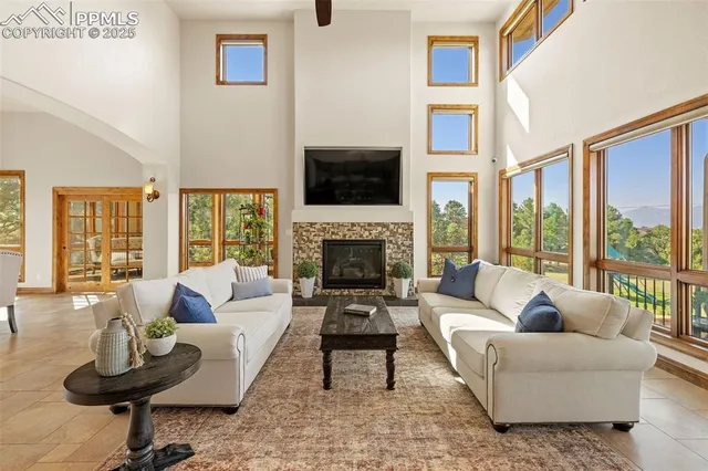 a living room with furniture fireplace and flat screen tv