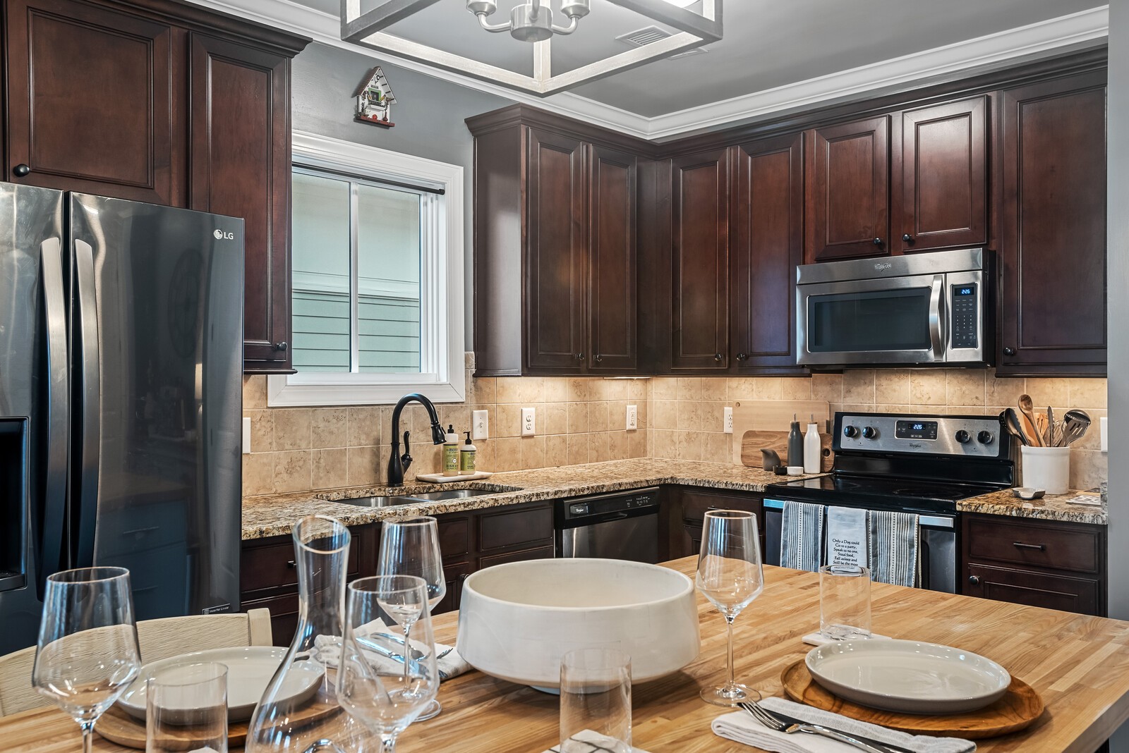 6151 Rural Plains Circle, Unit 301 Franklin, TN 37064 - Photo 4 of 17 a kitchen with granite countertop a sink stainless steel appliances and cabinets