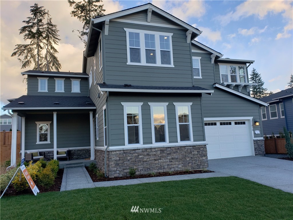 21819 33rd Drive Southeast, Unit 29 Bothell, WA 98021 - Photo 1 of 25 a front view of a house with garden