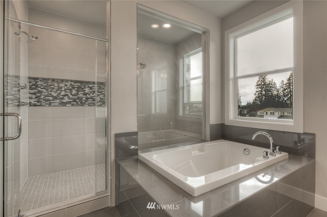 21819 33rd Drive Southeast, Unit 29 Bothell, WA 98021 - Photo 16 of 25 a bath tub sitting next to a shower