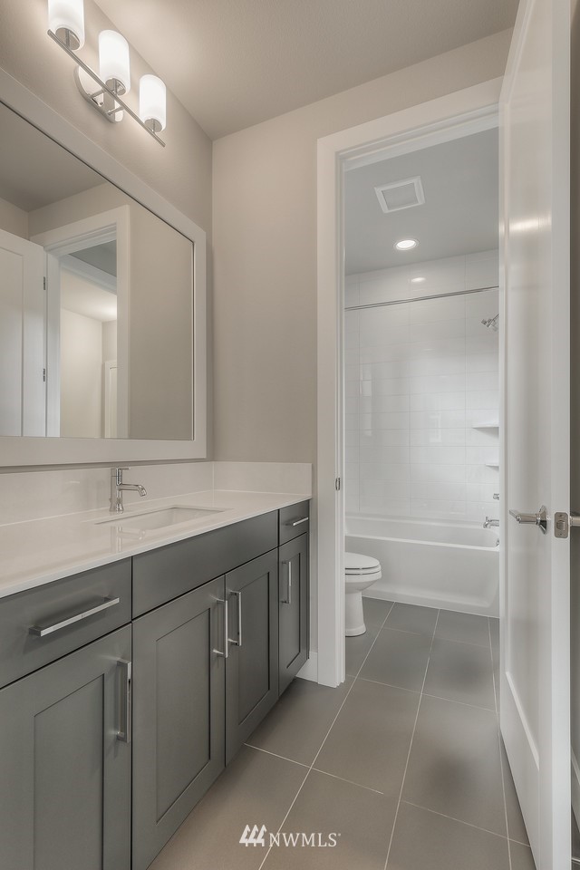 21819 33rd Drive Southeast, Unit 29 Bothell, WA 98021 - Photo 18 of 25 a bathroom with a sink a toilet and shower