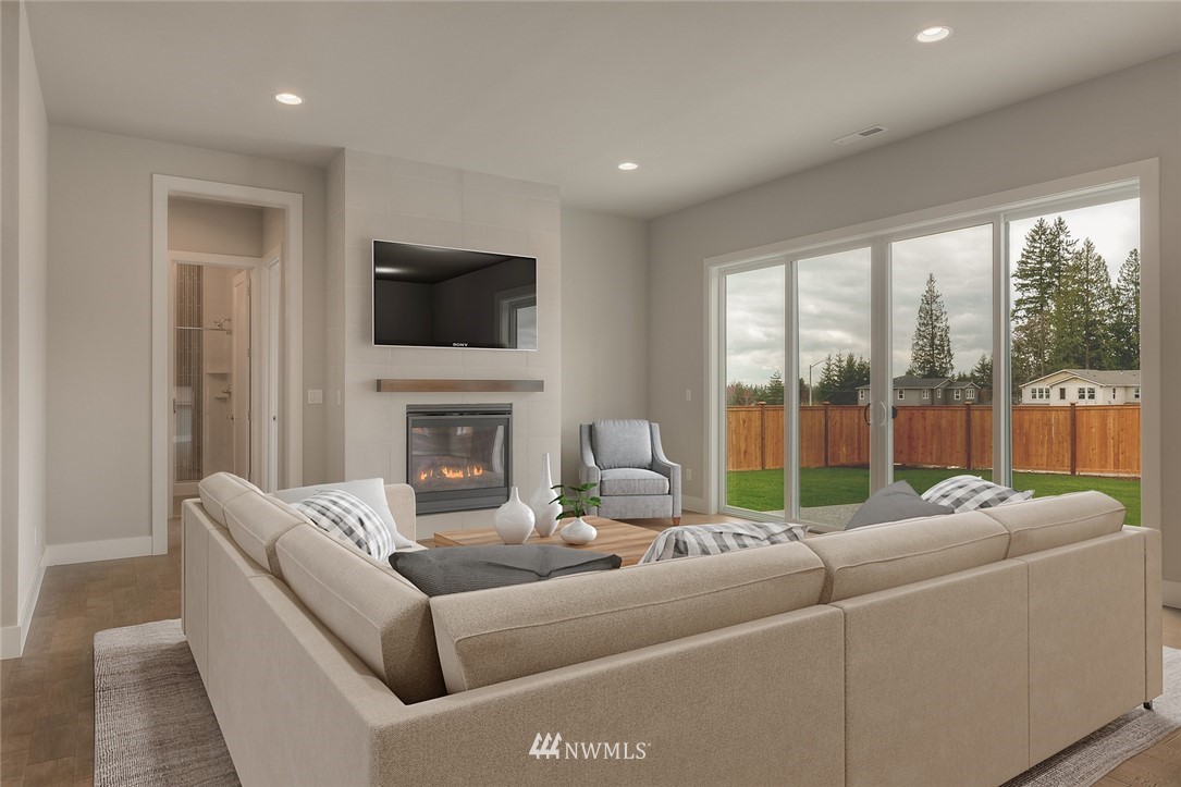 21819 33rd Drive Southeast, Unit 29 Bothell, WA 98021 - Photo 5 of 25 a living room with furniture a fireplace and a flat screen tv