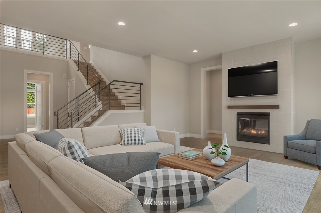 21819 33rd Drive Southeast, Unit 29 Bothell, WA 98021 - Photo 6 of 25 a living room with furniture fireplace and a flat screen tv
