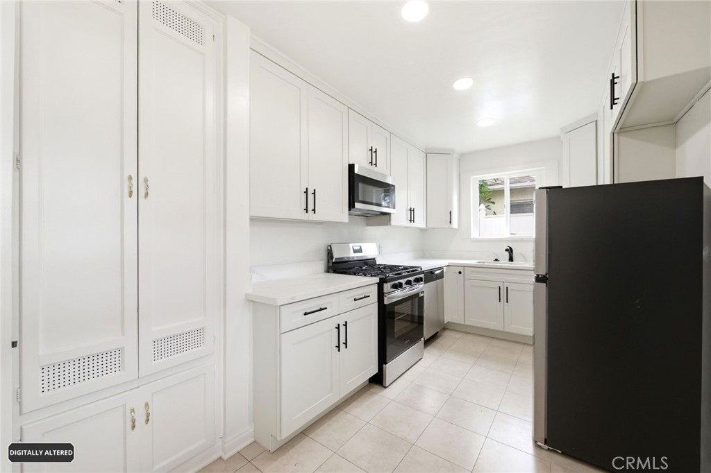 10539 Gridley Road Santa Fe Springs, CA 90670 - Photo 11 of 29 a kitchen with a refrigerator stove and sink