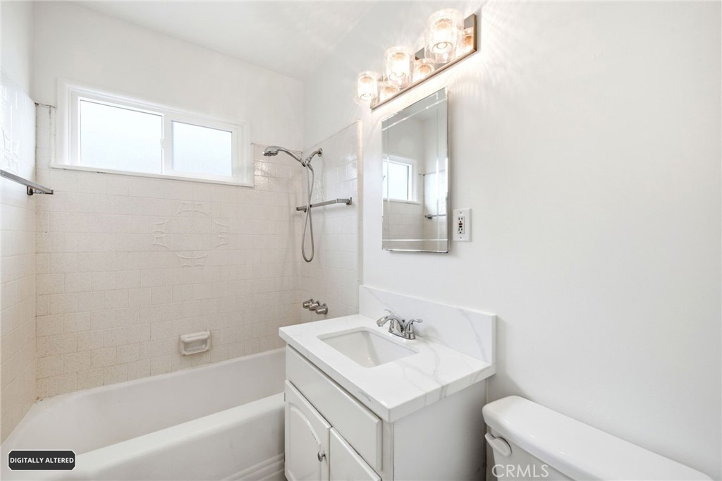 10539 Gridley Road Santa Fe Springs, CA 90670 - Photo 13 of 29 a bathroom with a sink toilet vanity and tub