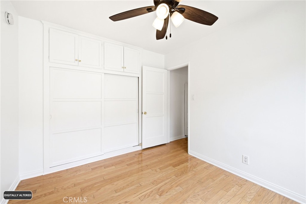10539 Gridley Road Santa Fe Springs, CA 90670 - Photo 16 of 29 a view of a room with closet and wooden floor