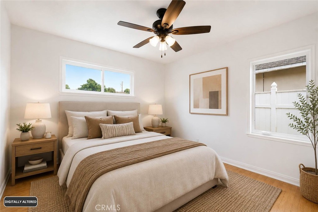 10539 Gridley Road Santa Fe Springs, CA 90670 - Photo 17 of 29 a bedroom with a bed and a painting on the wall
