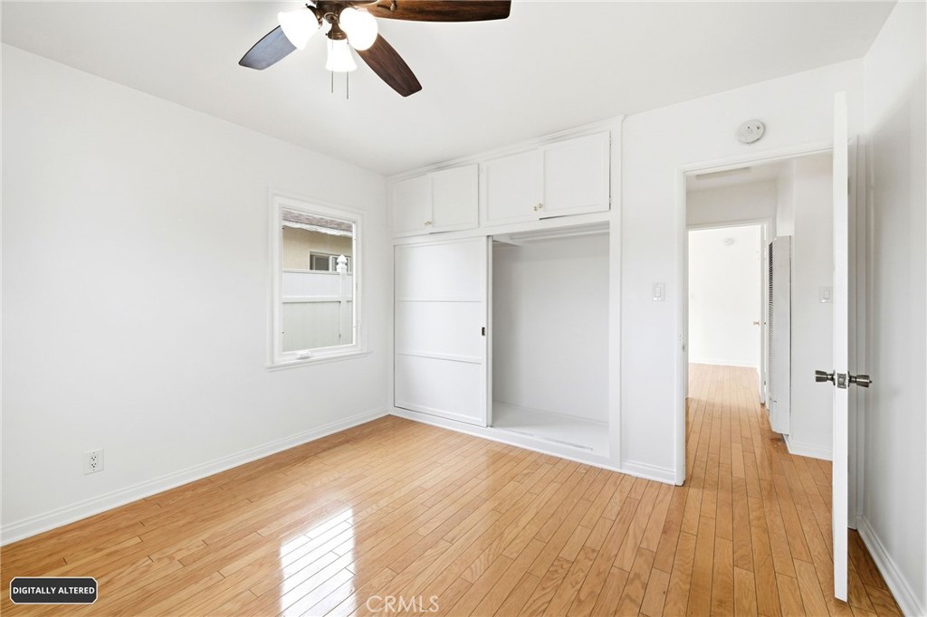 10539 Gridley Road Santa Fe Springs, CA 90670 - Photo 19 of 29 a view of empty room with wooden floor and ceiling fan