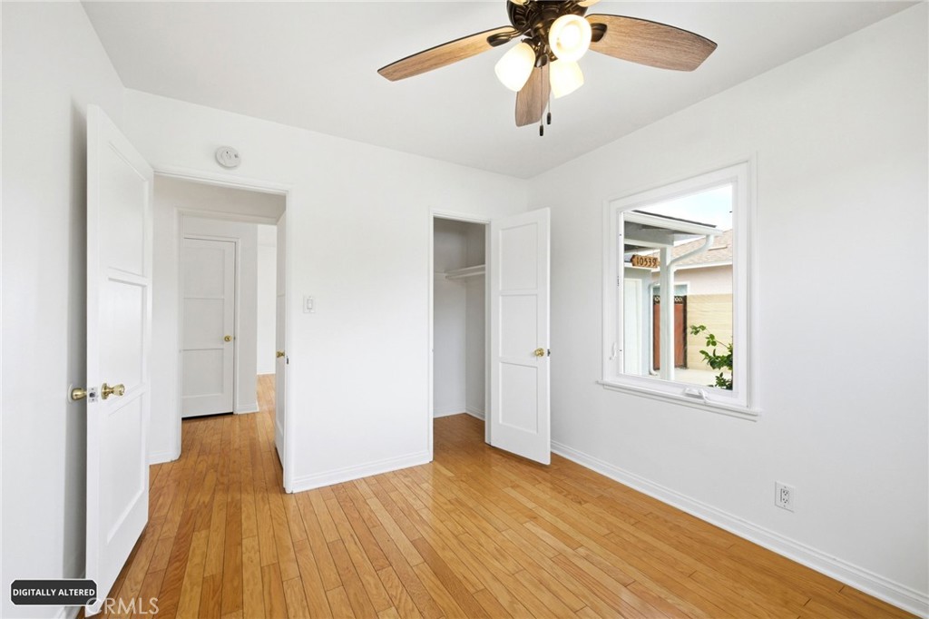 10539 Gridley Road Santa Fe Springs, CA 90670 - Photo 22 of 29 wooden floor in an empty room with a window