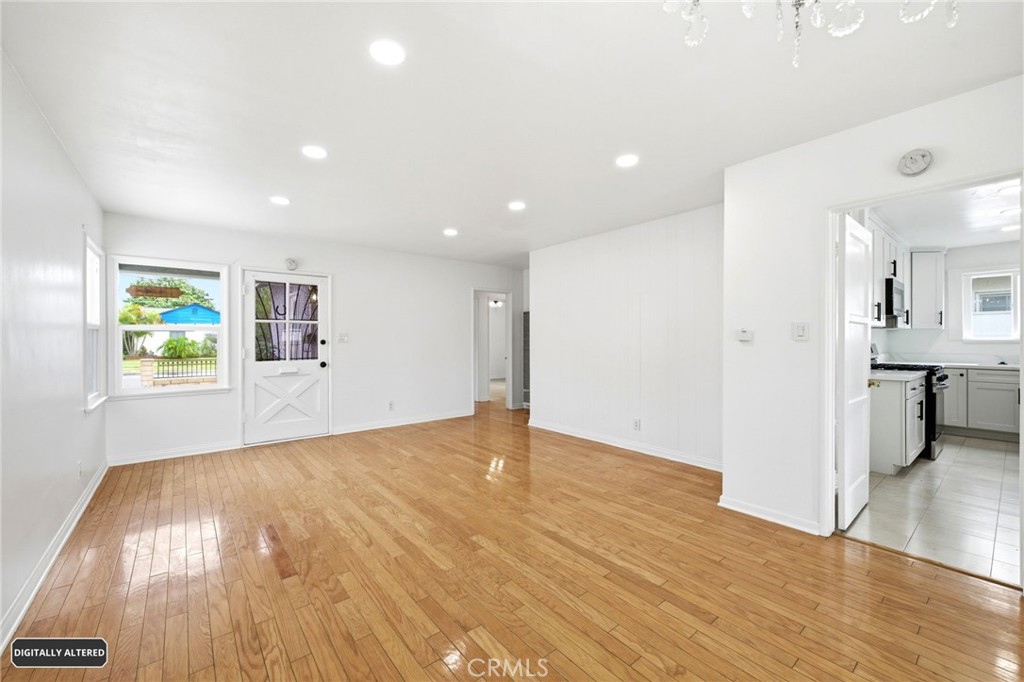 10539 Gridley Road Santa Fe Springs, CA 90670 - Photo 5 of 29 a view of an empty room with wooden floor and a window