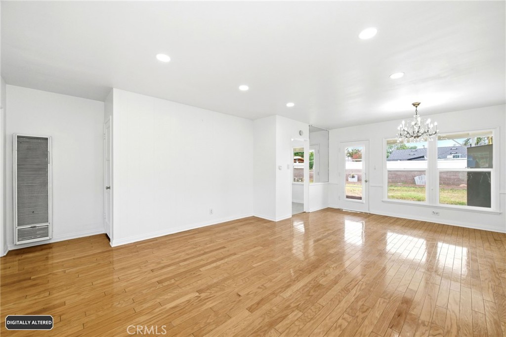 10539 Gridley Road Santa Fe Springs, CA 90670 - Photo 6 of 29 a view of a big room with wooden floor and windows