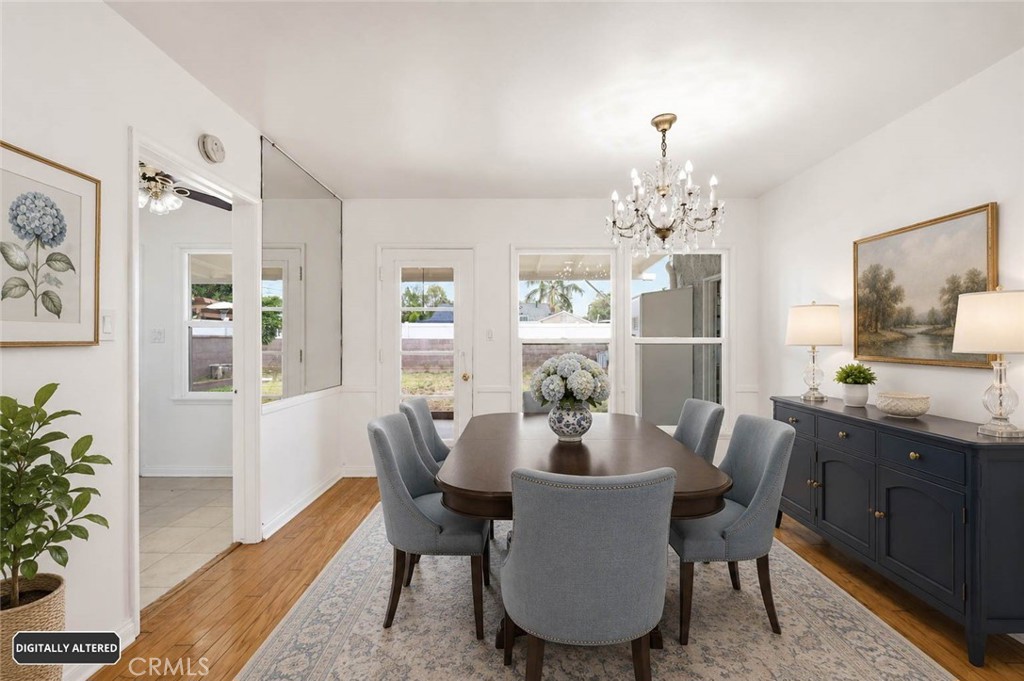 10539 Gridley Road Santa Fe Springs, CA 90670 - Photo 8 of 29 a dining room with furniture a rug and a chandelier