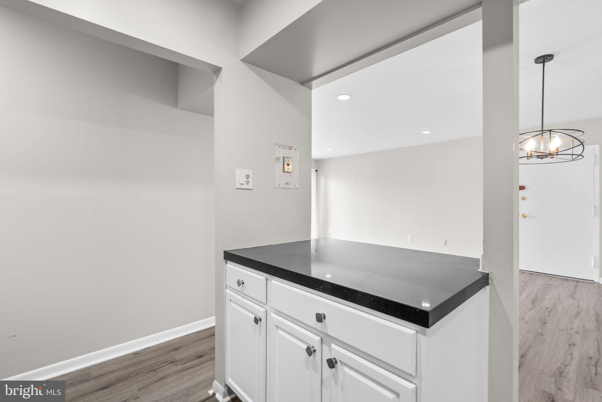 10121 Prince Place, Unit 30210B Upper Marlboro, MD 20774 - Photo 12 of 24 a view of kitchen island with wooden floor