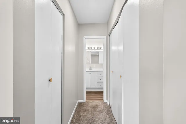 a view of hallway with wooden floor