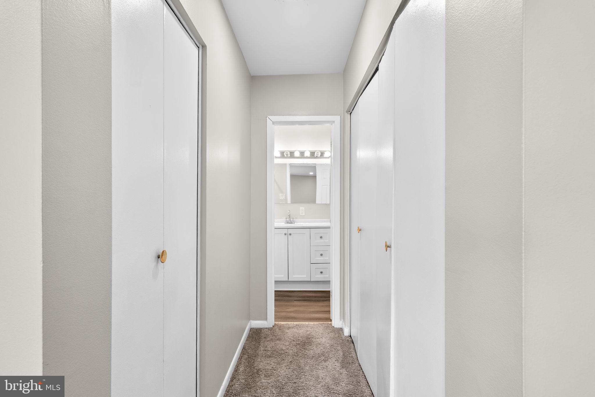 10121 Prince Place, Unit 30210B Upper Marlboro, MD 20774 - Photo 16 of 24 a view of hallway with wooden floor
