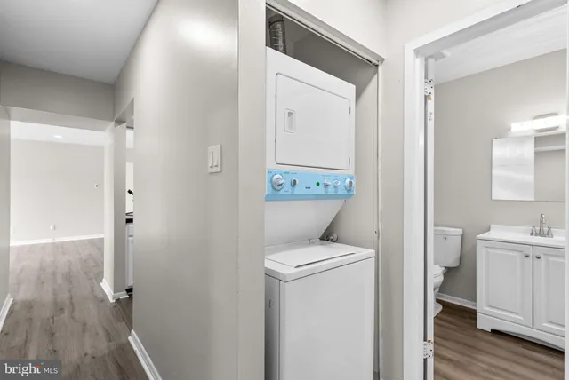 a view of bathroom with a toilet sink and mirror