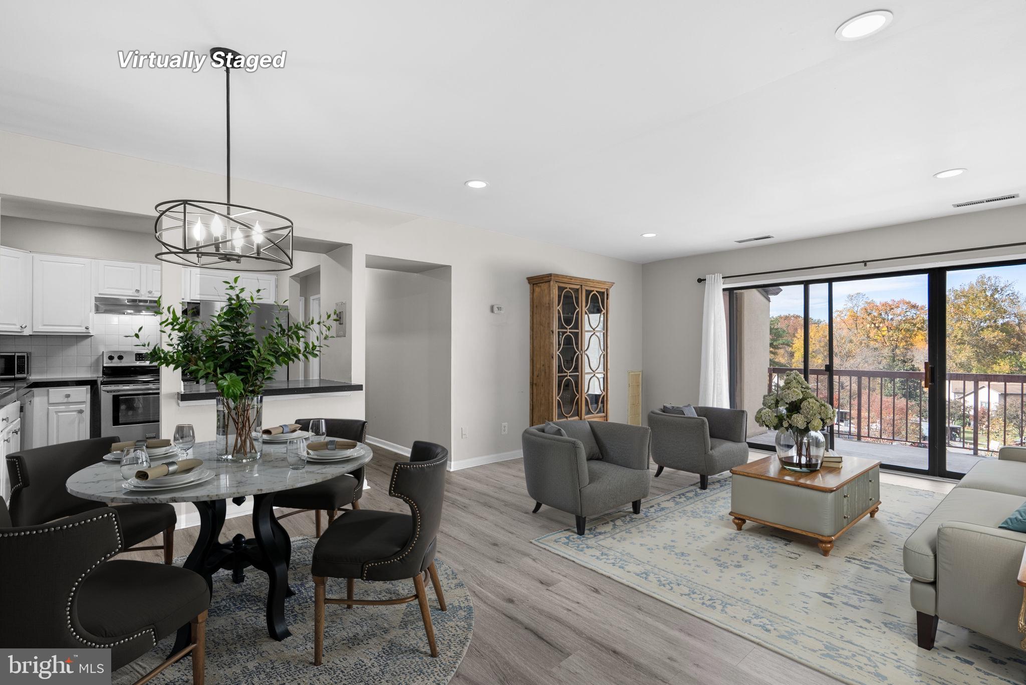 10121 Prince Place, Unit 30210B Upper Marlboro, MD 20774 - Photo 4 of 24 a view of a dining room with furniture window and outside view