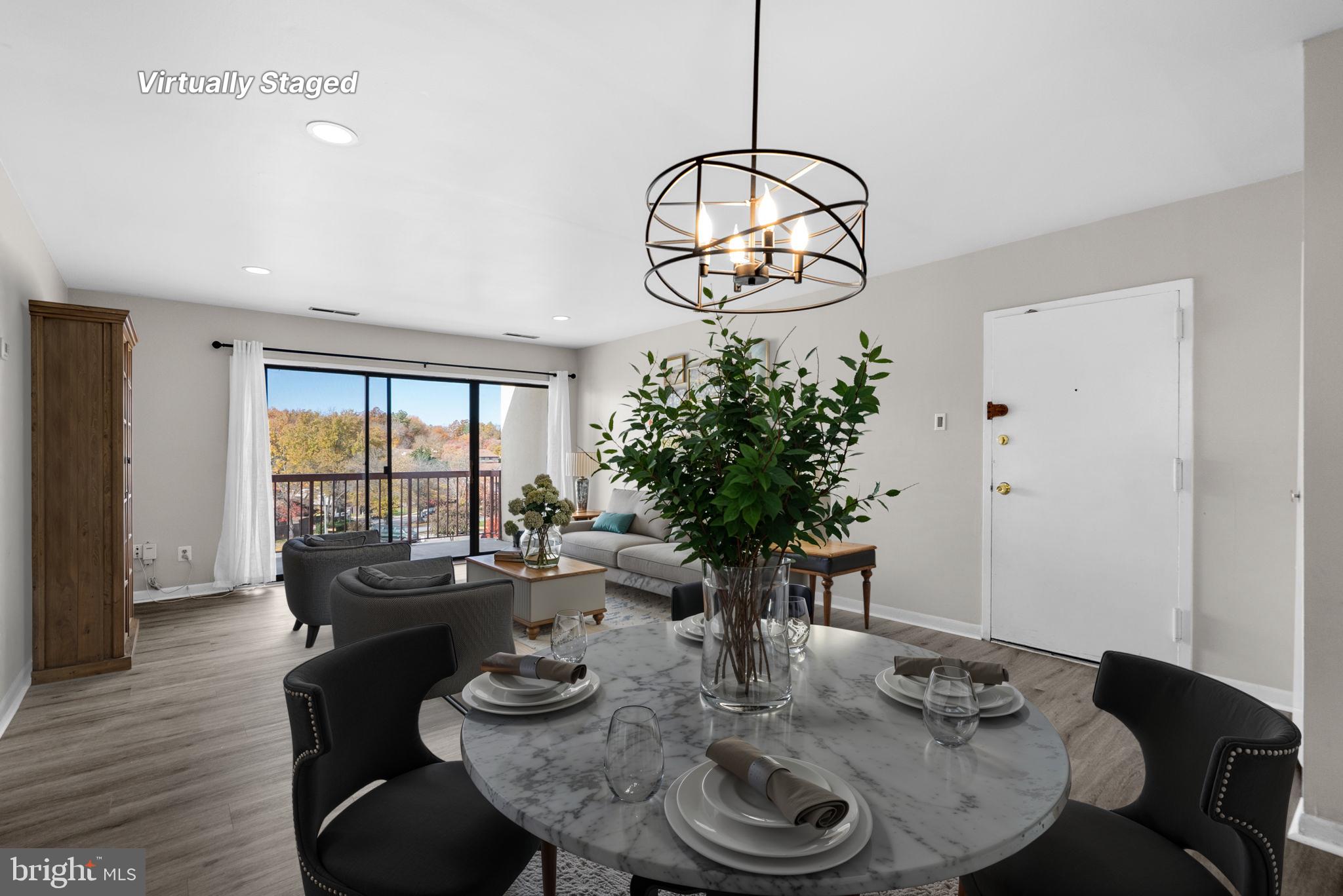 10121 Prince Place, Unit 30210B Upper Marlboro, MD 20774 - Photo 7 of 24 a view of a dining room with furniture window and wooden floor