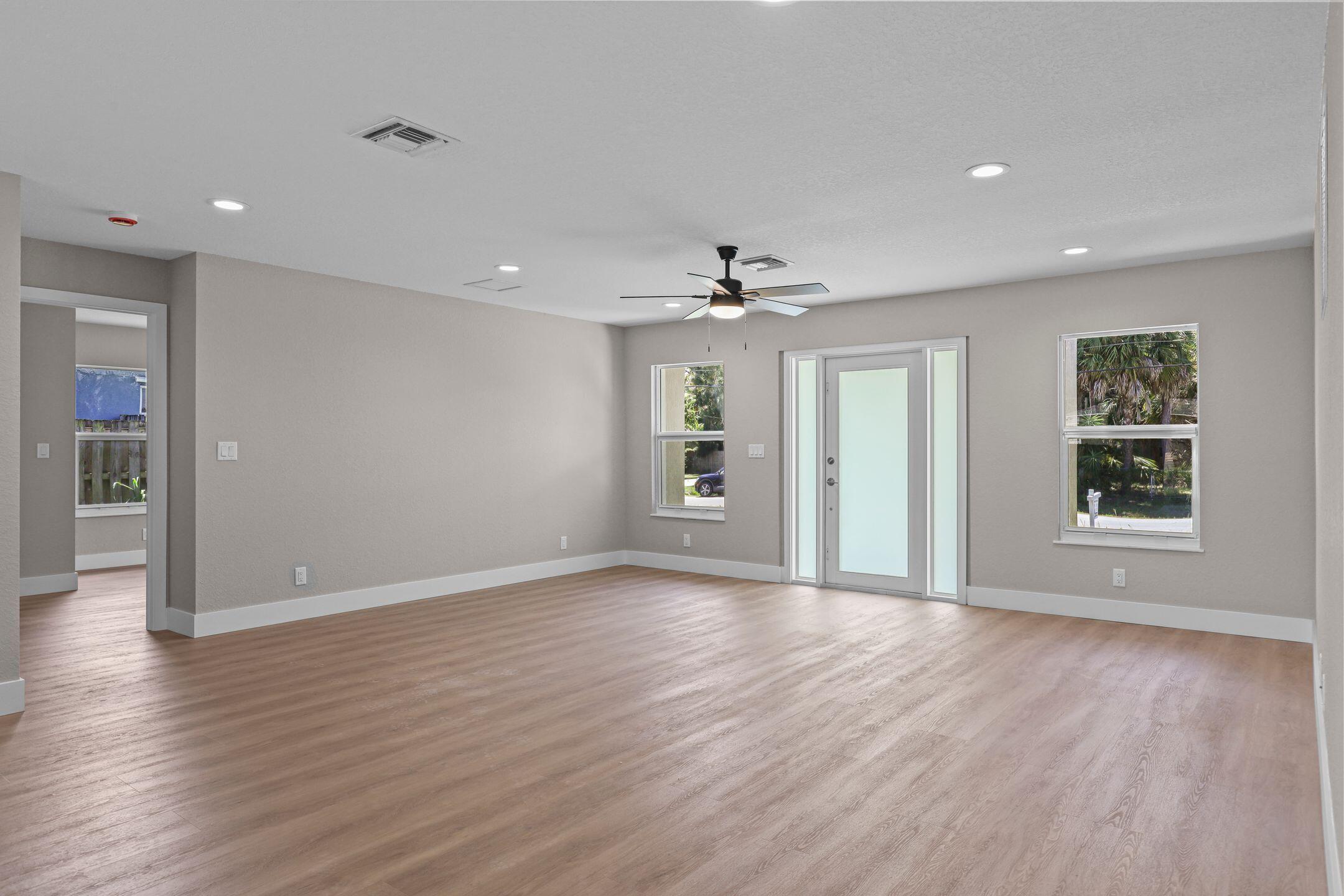 4611 Sunset Boulevard Fort Pierce, FL 34982 - Photo 11 of 28 a view of an empty room with wooden floor and a window