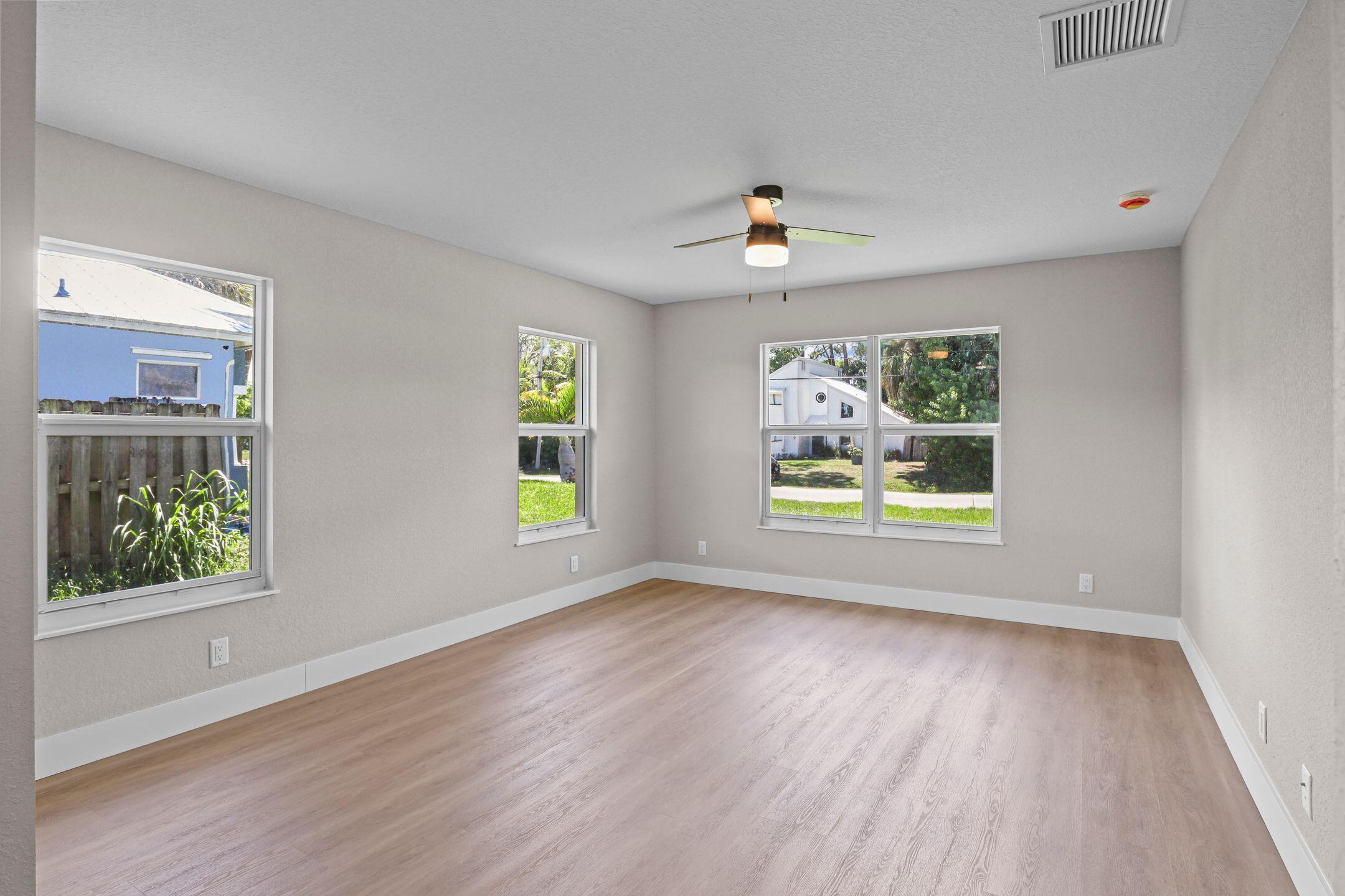 4611 Sunset Boulevard Fort Pierce, FL 34982 - Photo 12 of 28 a view of an empty room with window and wooden floor