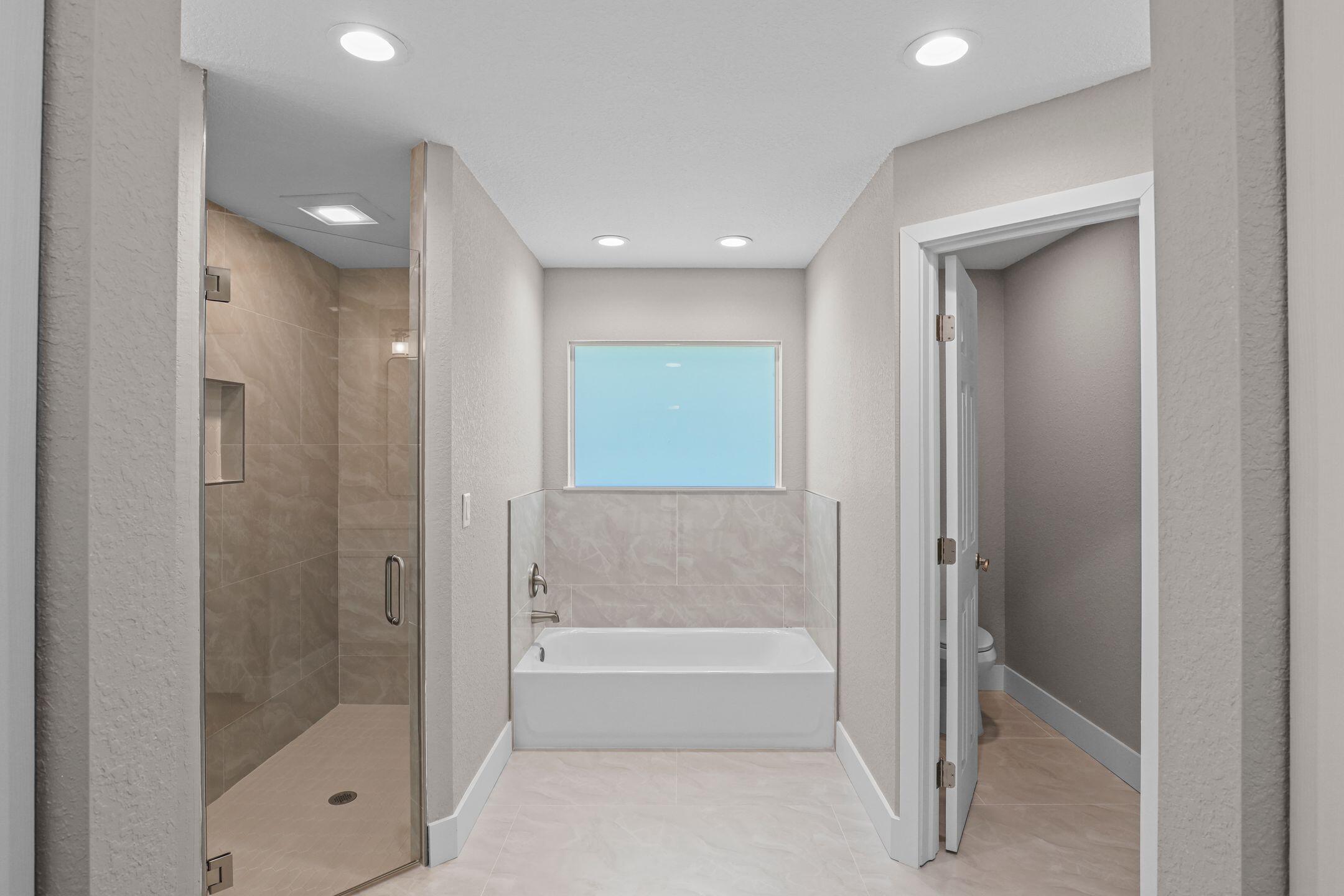 4611 Sunset Boulevard Fort Pierce, FL 34982 - Photo 16 of 28 a bathroom with a bathtub and a shower