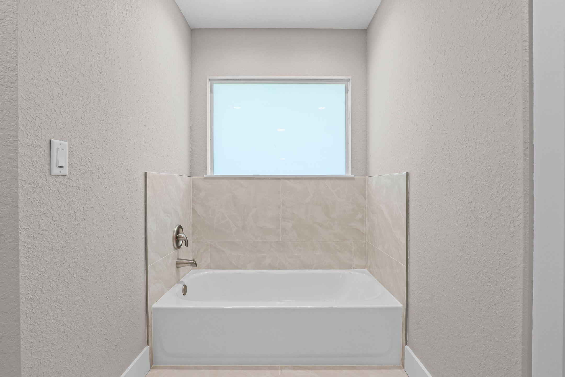 4611 Sunset Boulevard Fort Pierce, FL 34982 - Photo 18 of 28 a bathroom with a bathtub