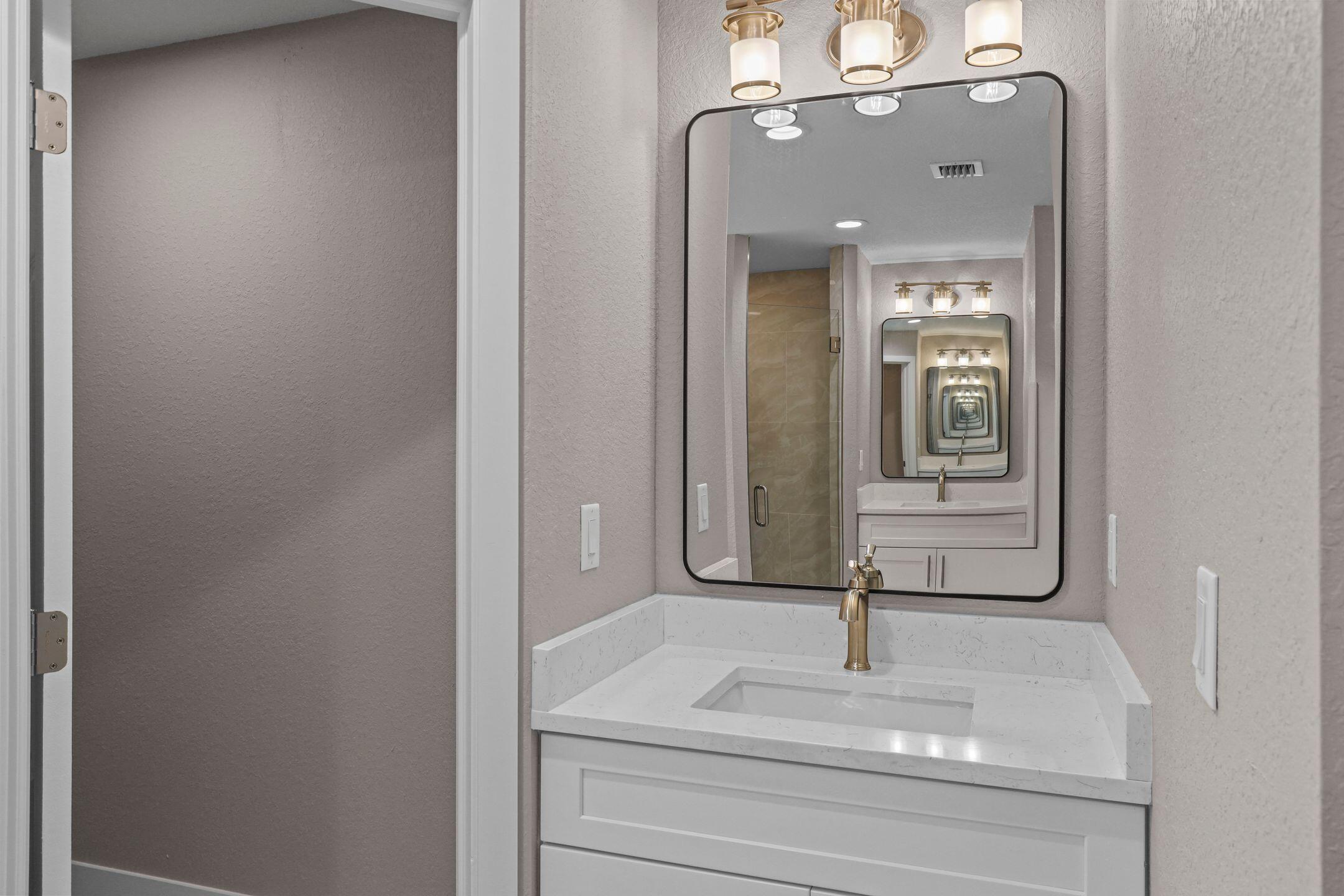 4611 Sunset Boulevard Fort Pierce, FL 34982 - Photo 19 of 28 a bathroom with a sink and mirror