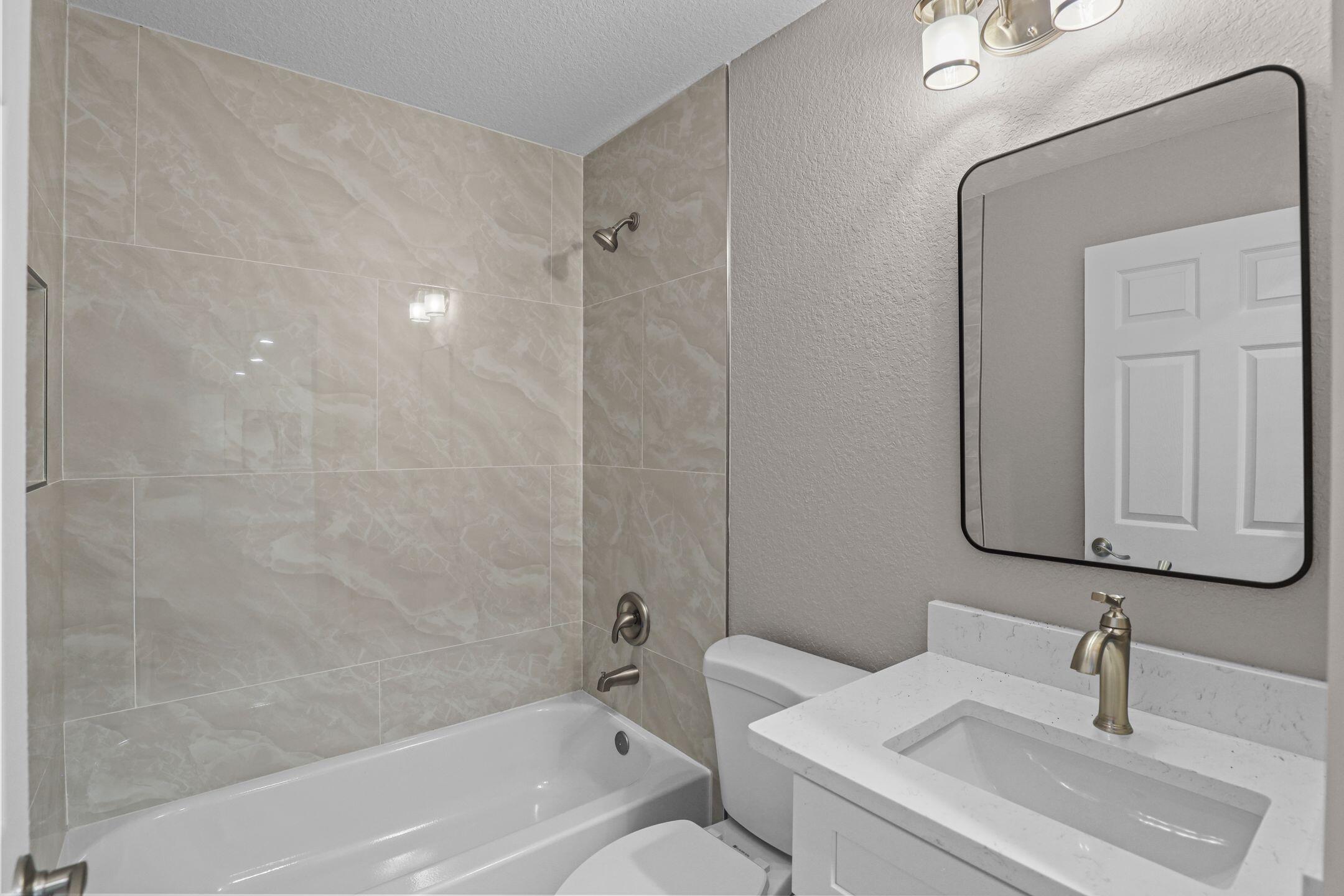 4611 Sunset Boulevard Fort Pierce, FL 34982 - Photo 24 of 28 a bathroom with a sink a toilet and shower