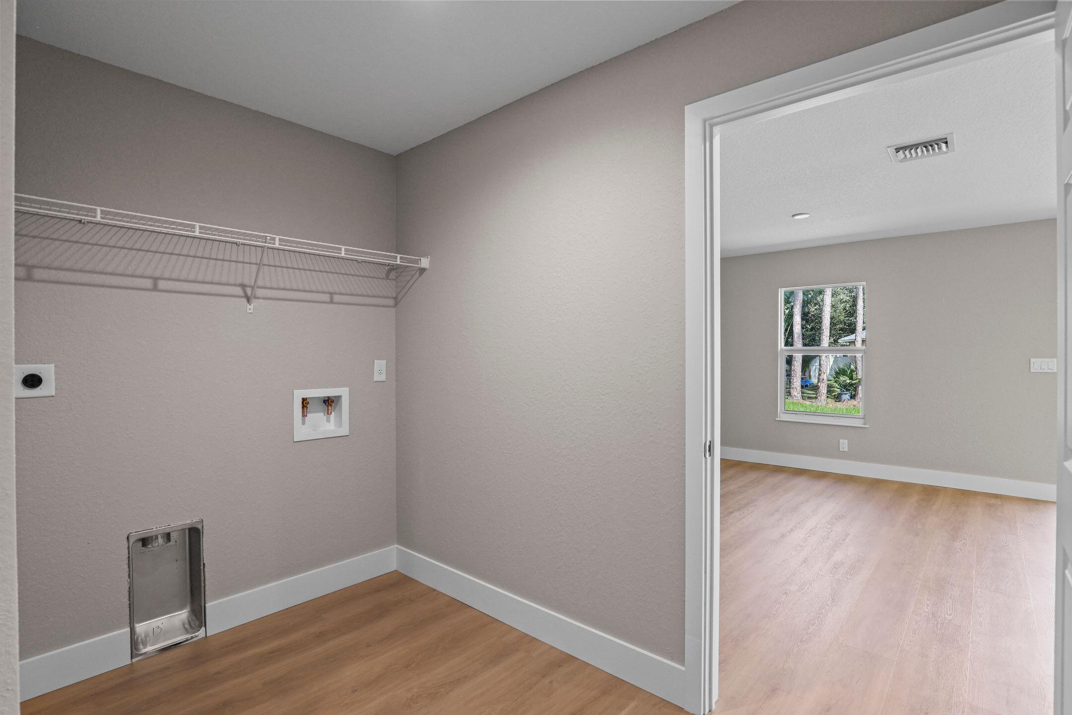 4611 Sunset Boulevard Fort Pierce, FL 34982 - Photo 25 of 28 a view of an empty room with wooden floor and a window