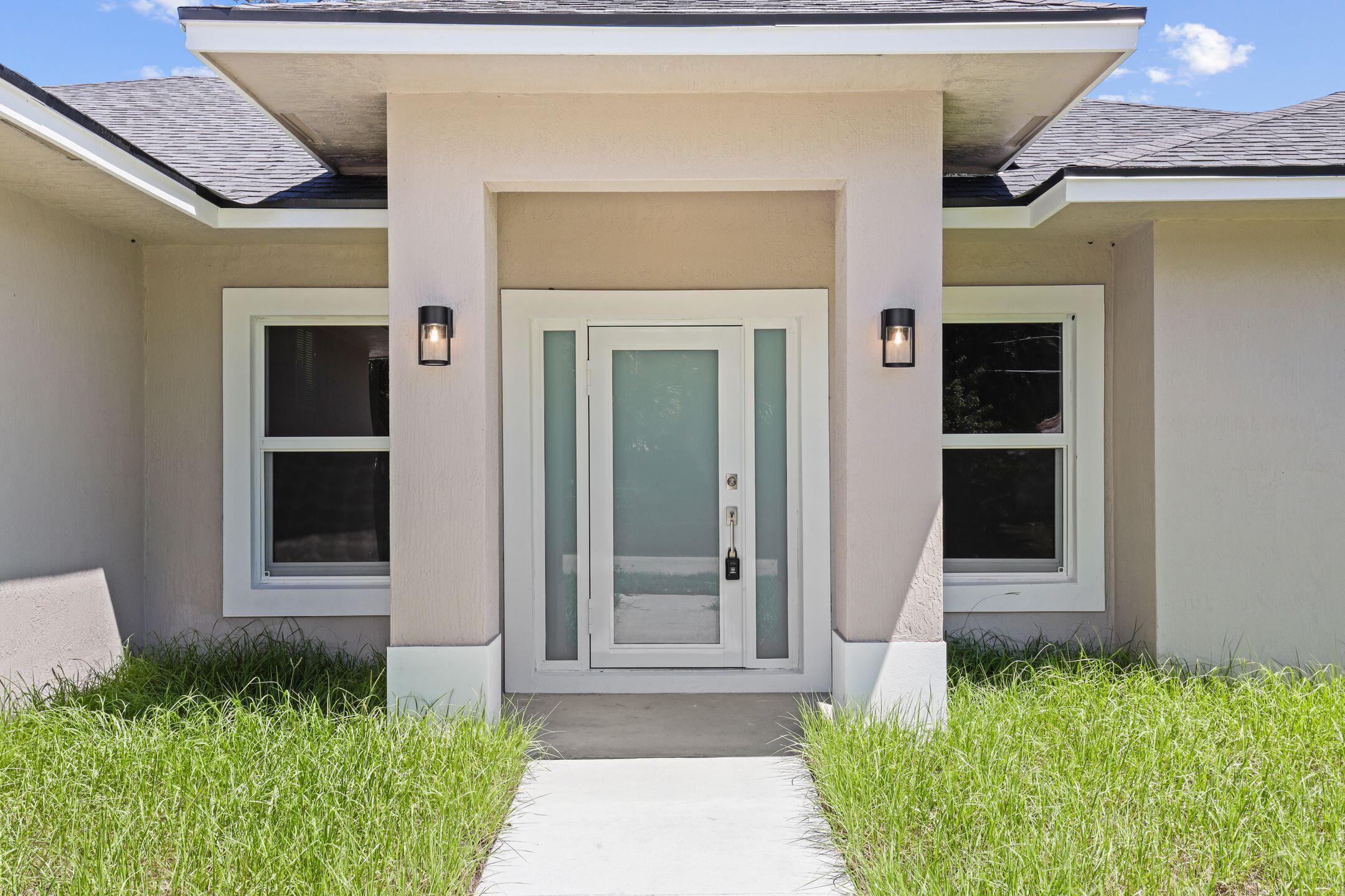 4611 Sunset Boulevard Fort Pierce, FL 34982 - Photo 3 of 28 a front view of a house with a yard