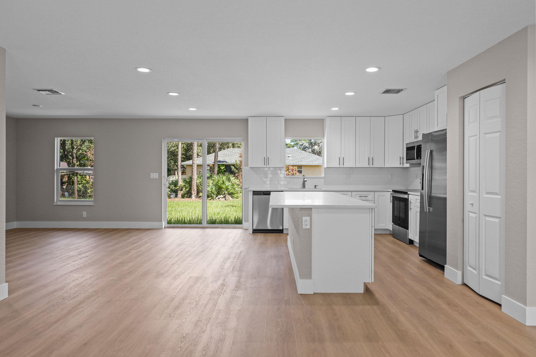 4611 Sunset Boulevard Fort Pierce, FL 34982 - Photo 8 of 28 a kitchen with a refrigerator and a stove top oven