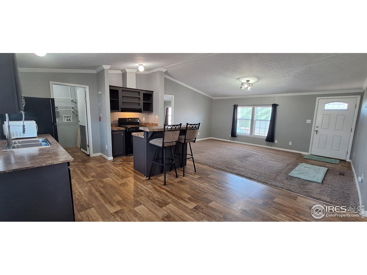 2500 East Harmony Road, Unit 439 Fort Collins, CO 80528 - Photo 4 of 13 a living room with furniture and a flat screen tv