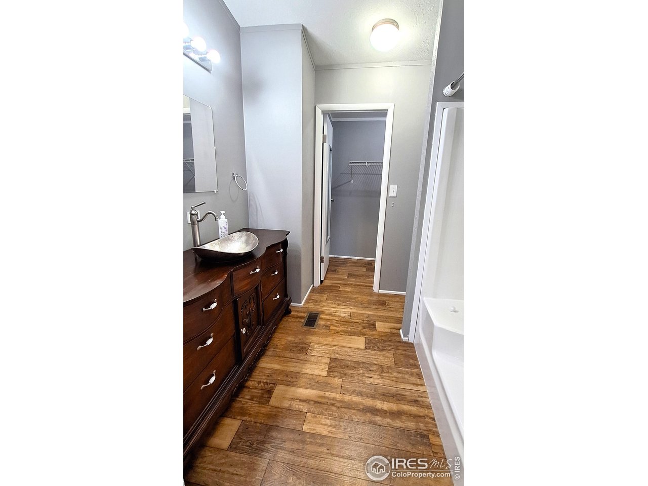2500 East Harmony Road, Unit 439 Fort Collins, CO 80528 - Photo 9 of 13 a spacious bathroom with a sink and a mirror