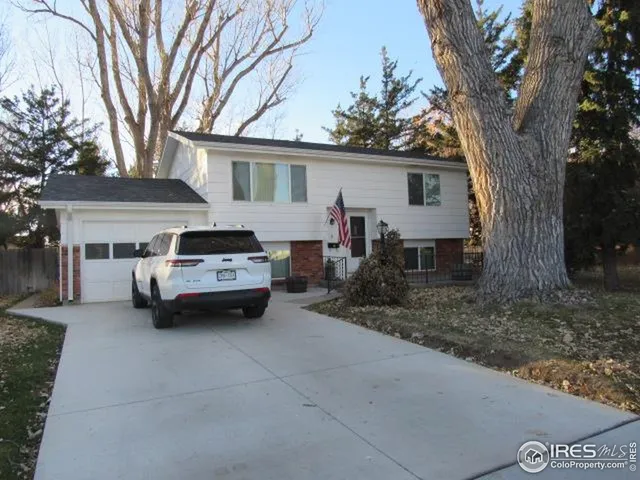 a car parked in front of a white house