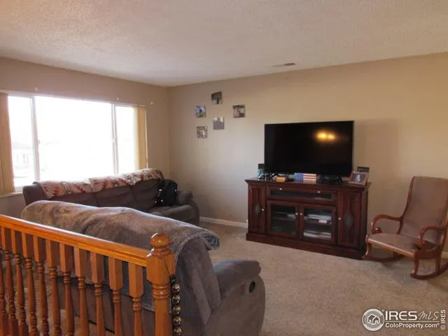 a room with furniture and a flat screen tv